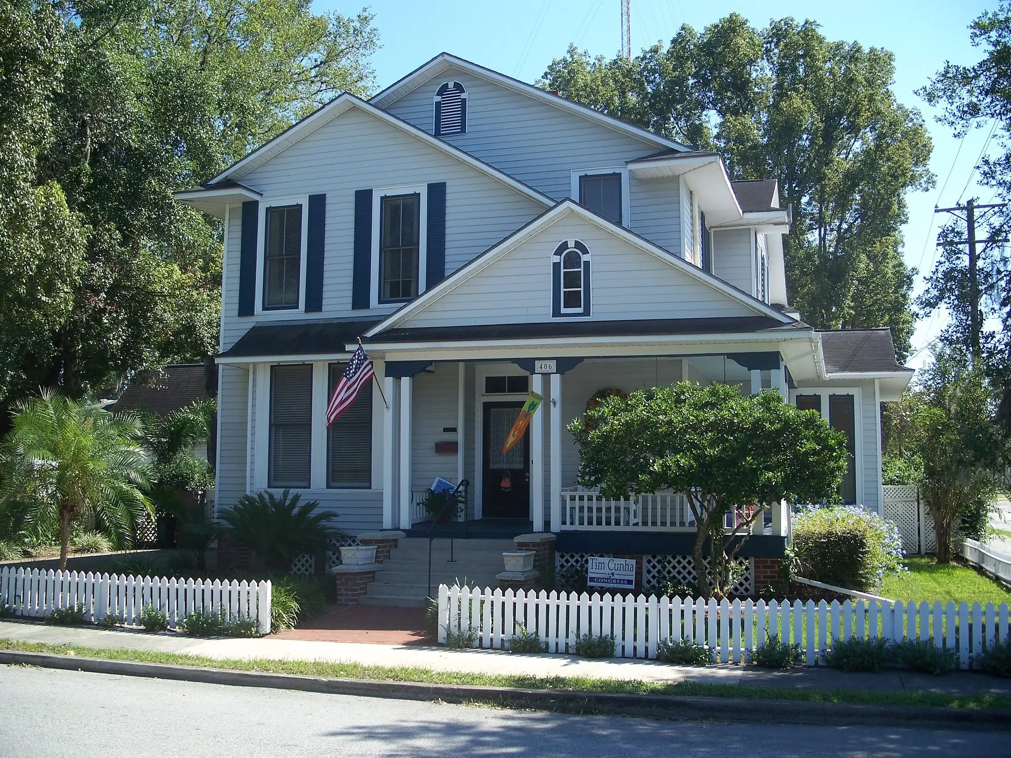 Two-story historic Ocala house with a porch and white picket fence