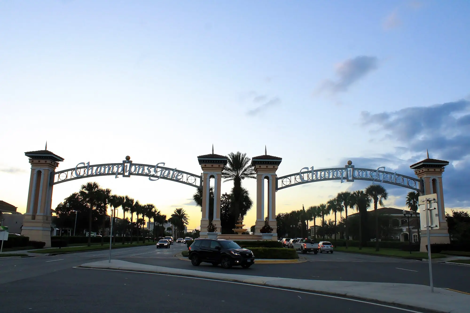 Palm-lined entrance arches at ChampionsGate at dusk