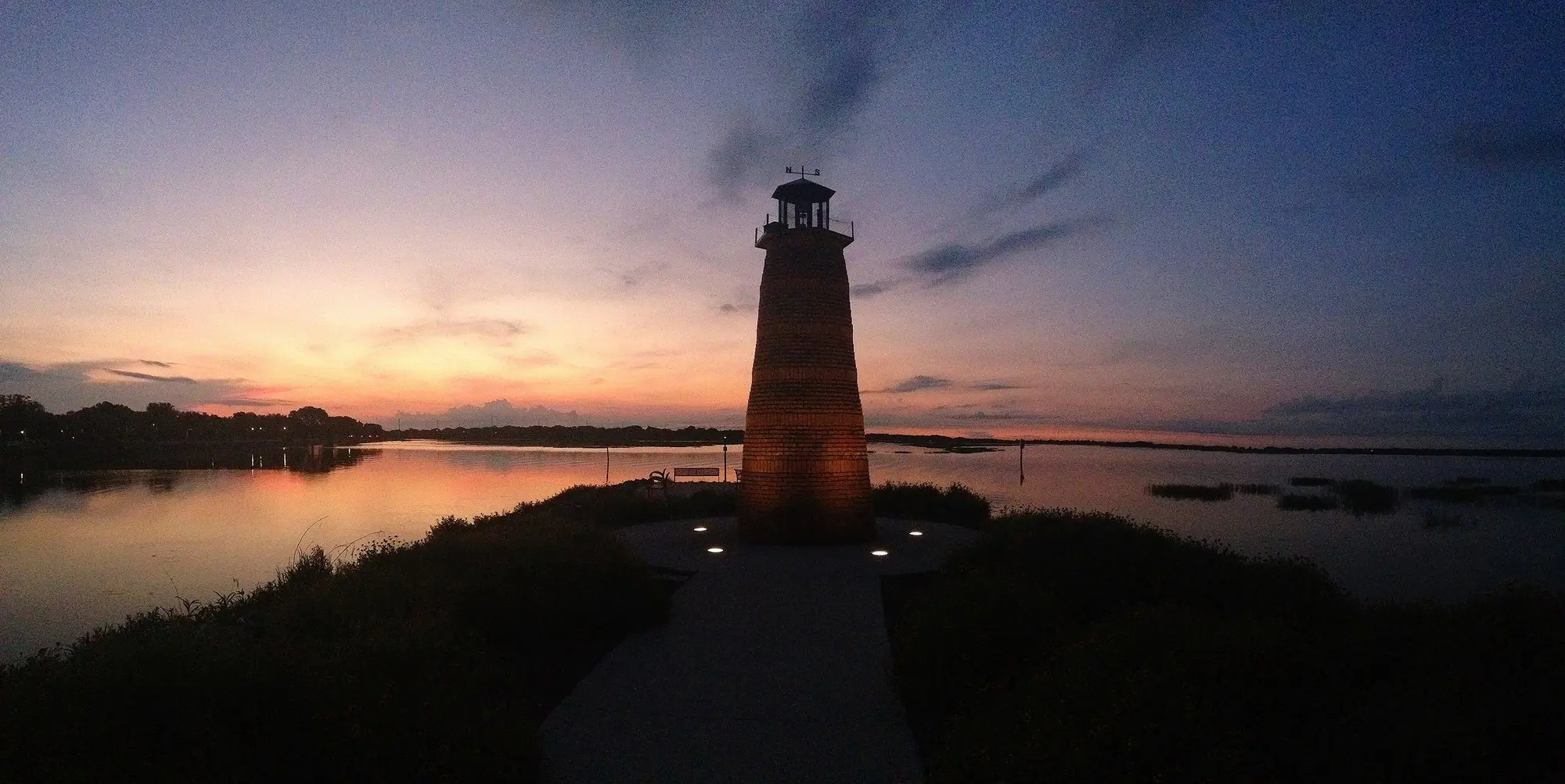 Sunrise over Lake Tohopekaliga with the lighthouse at Kissimmee Lakefront Park in silhouette