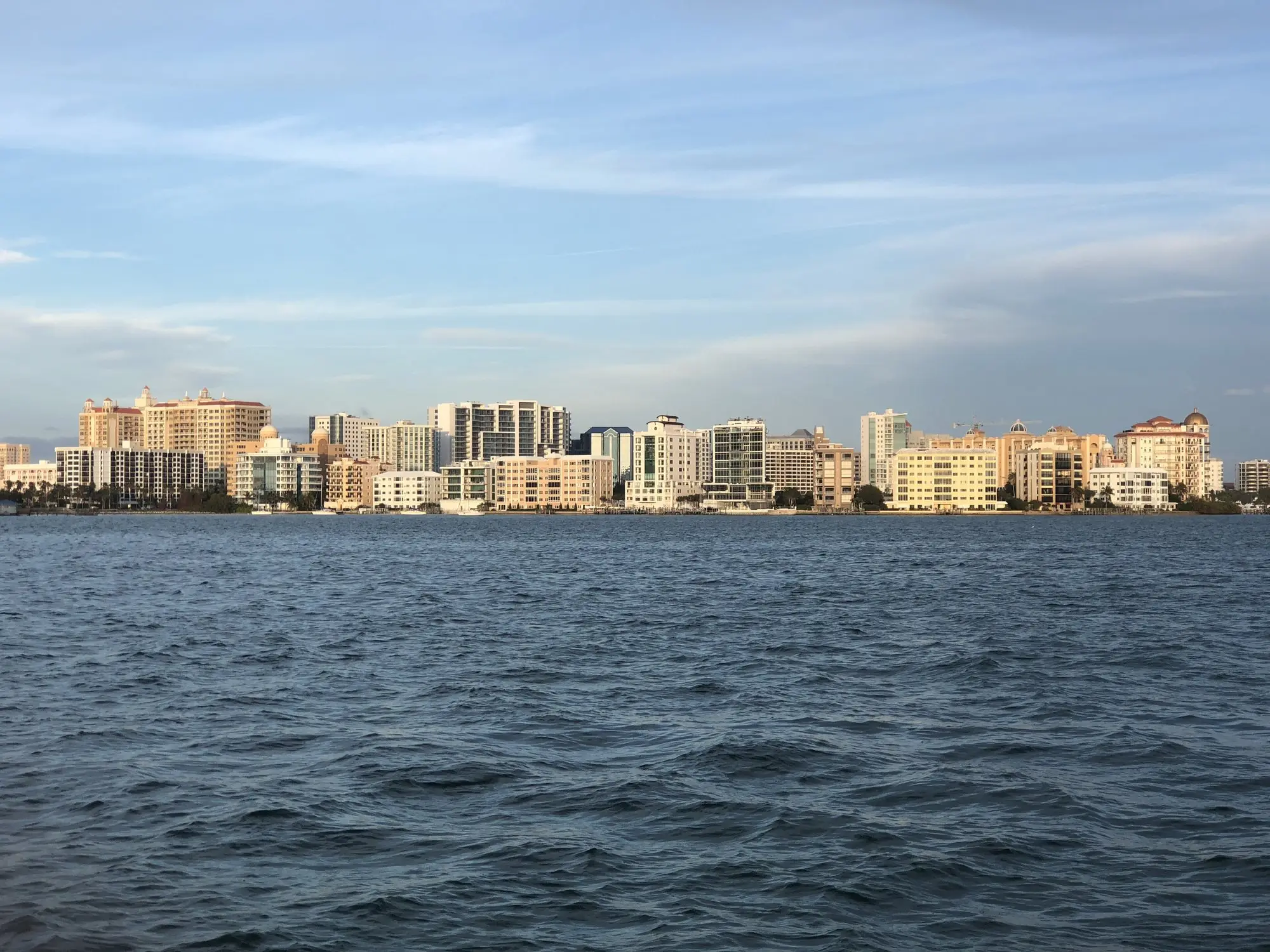 The downtown Sarasota skyline seen across the blue water of Sarasota Bay